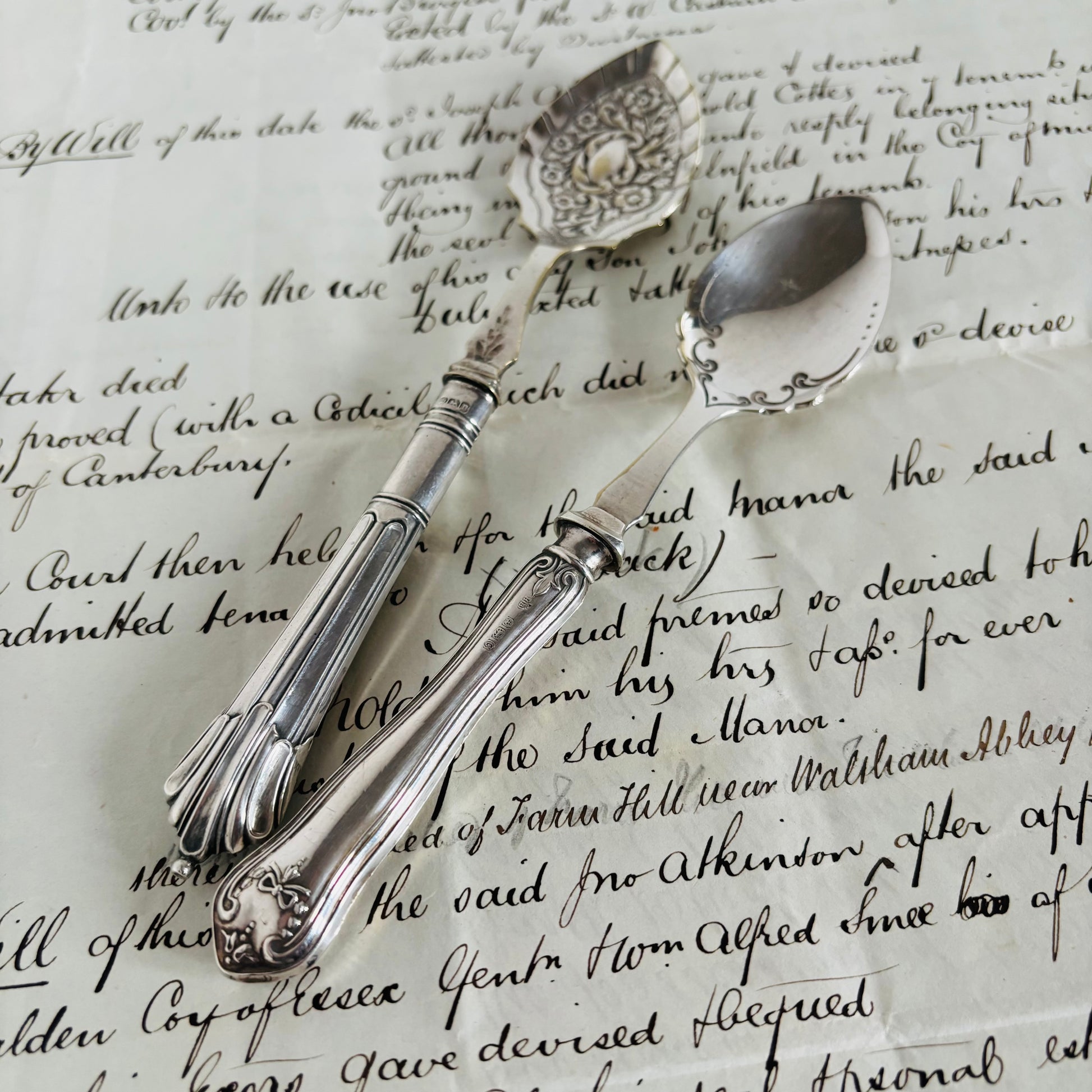 Decorative silver spoons on a piece of paper with text