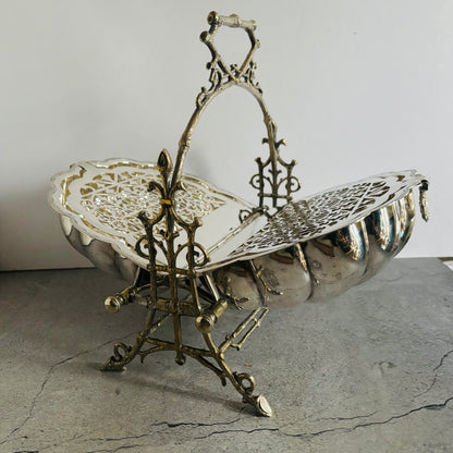 Decorative silver basket with intricate designs on a gray surface