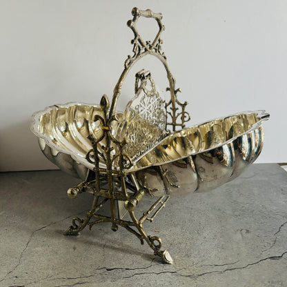 Decorative silver and brass basket on a textured surface with a neutral background