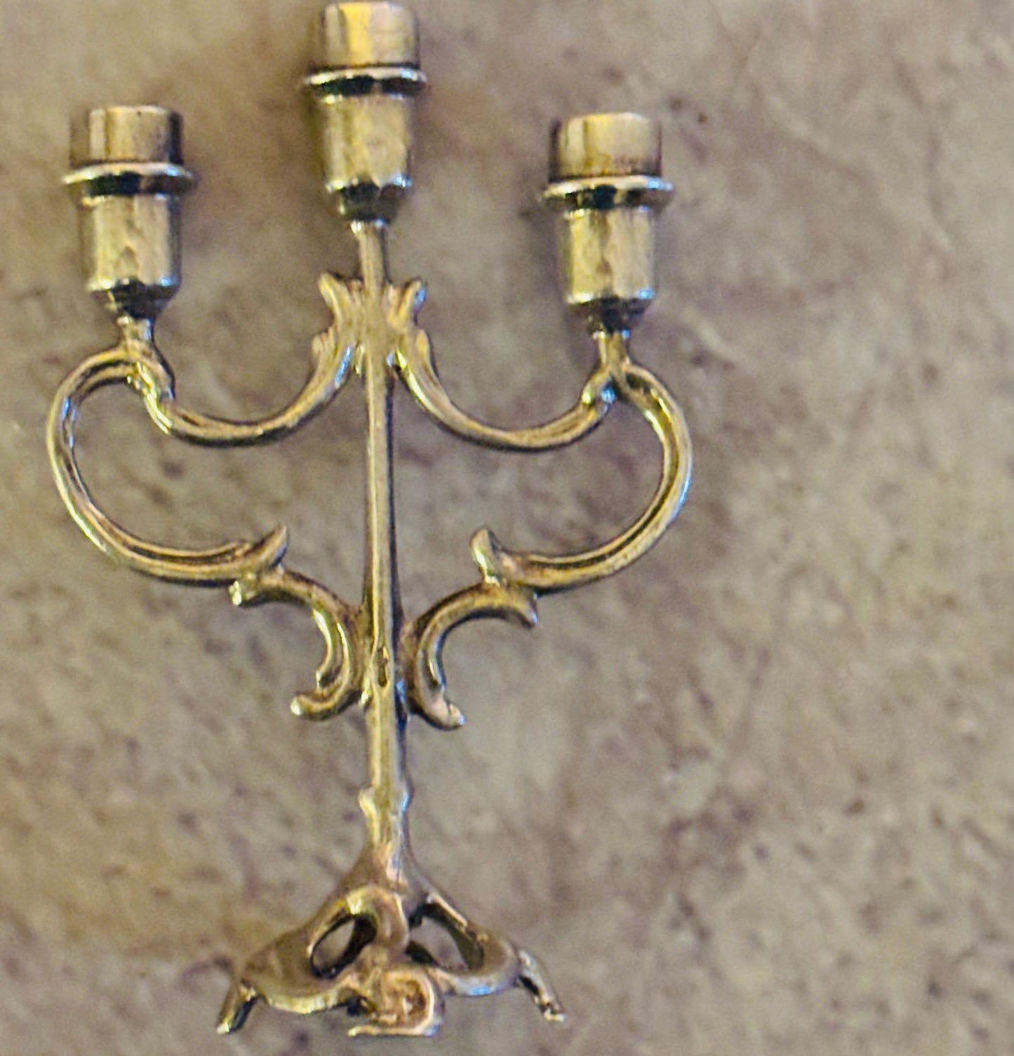 Decorative gold candelabra on a beige background