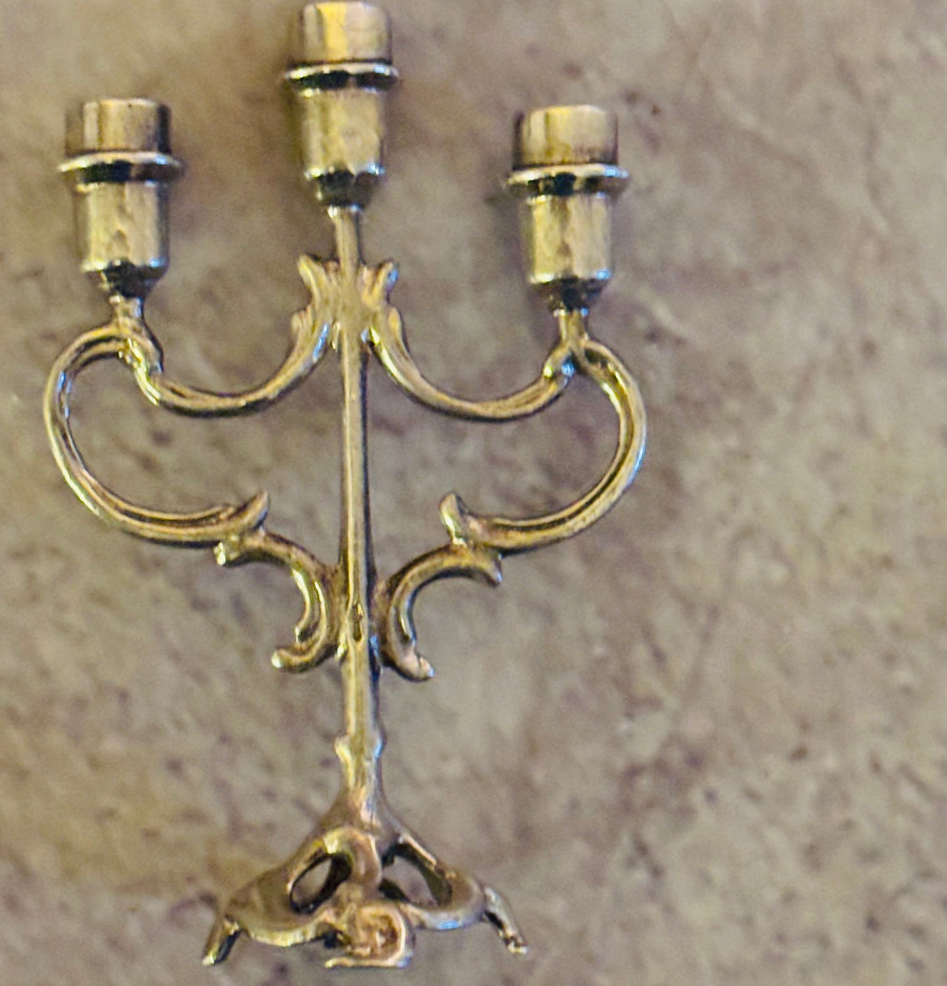 Decorative gold candelabra on a beige background
