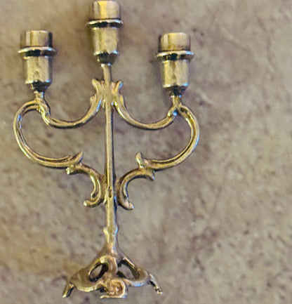 Decorative gold candelabra on a beige background
