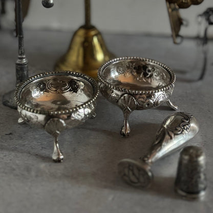 Collection of silver decorative items on a textured surface