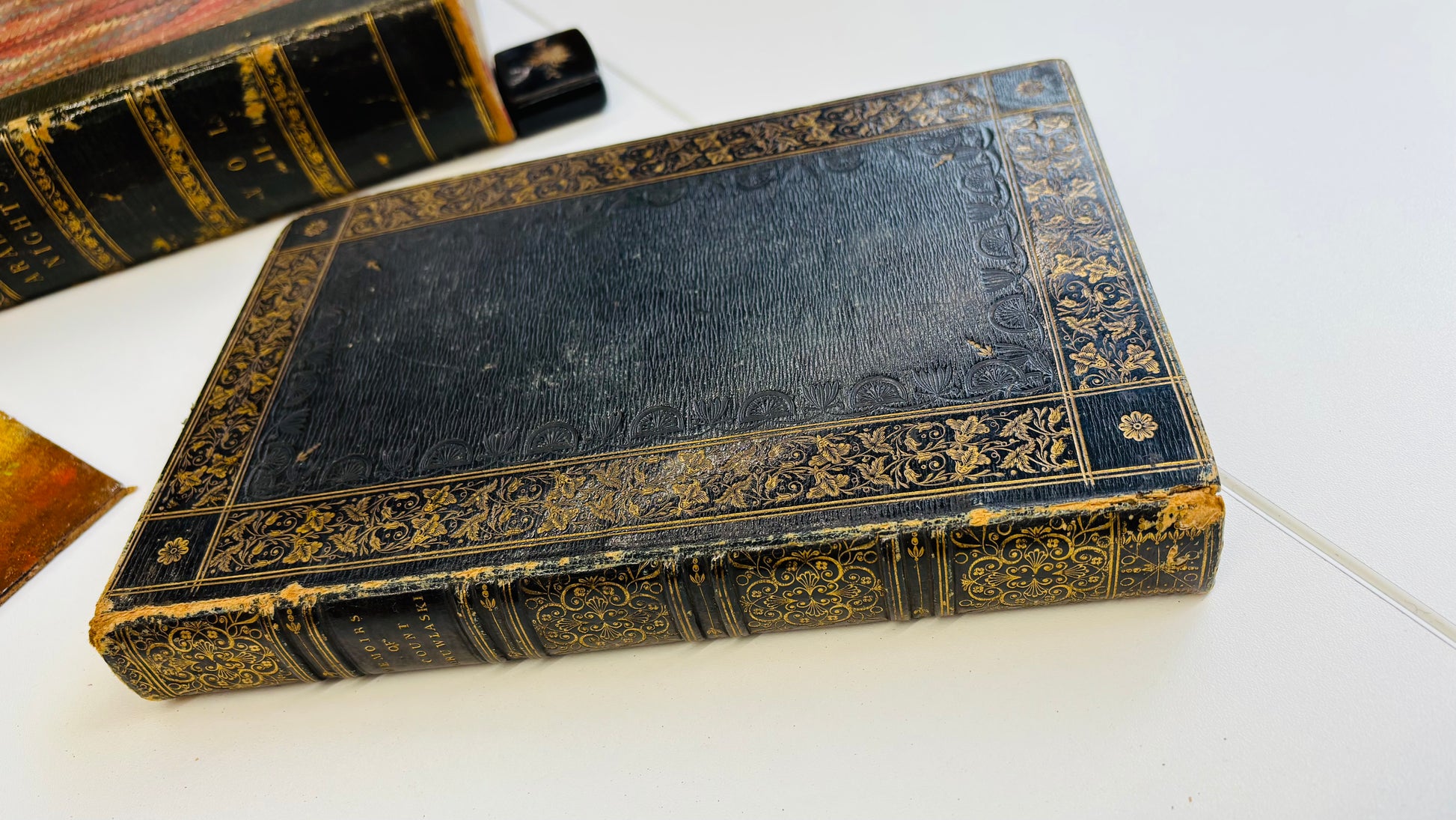 Antique  book with ornate gold embossing on a white surface