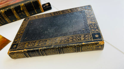 Antique  book with ornate gold embossing on a white surface