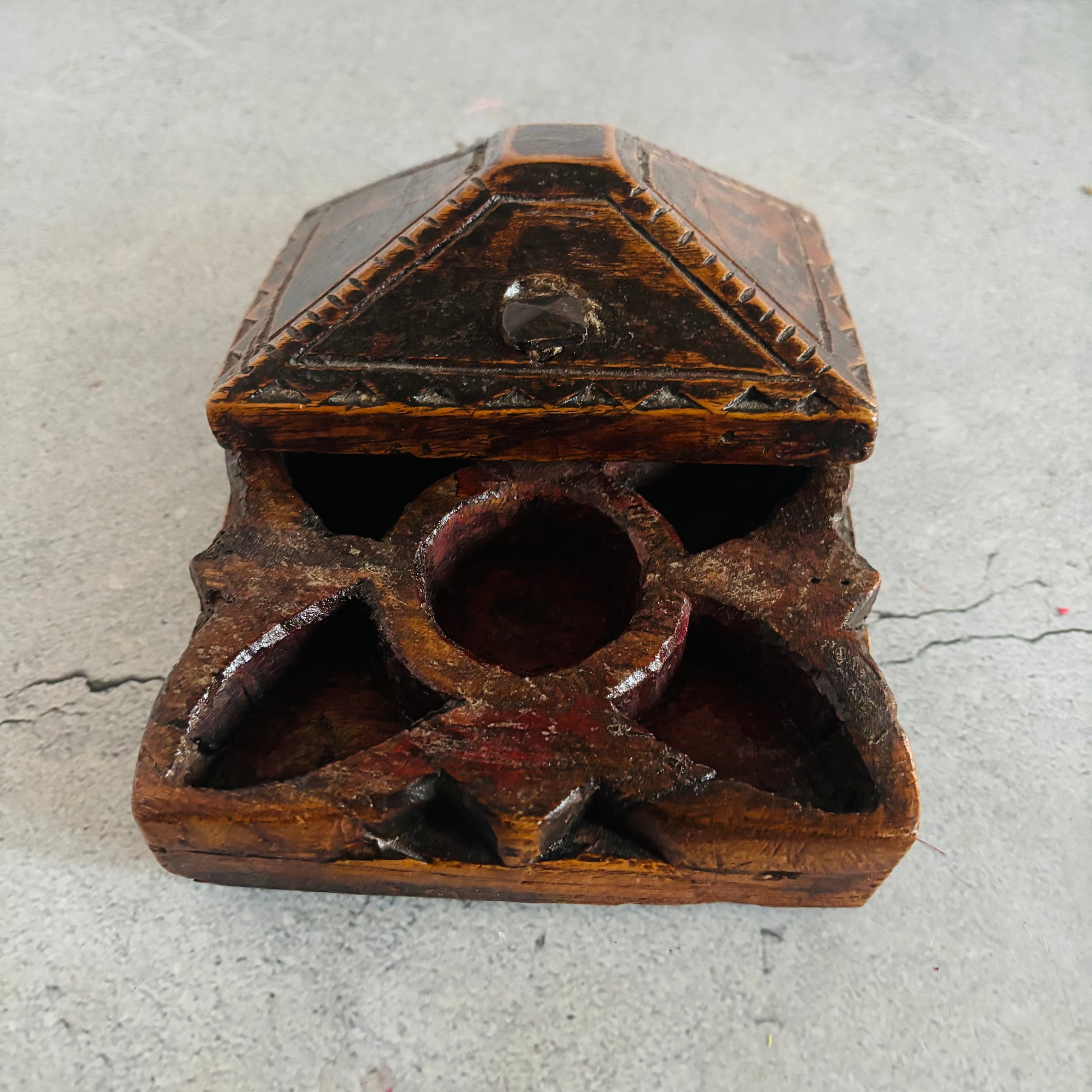 Wooden box with geometric design on a gray surface