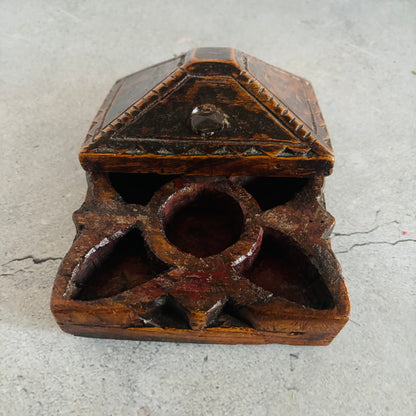 Wooden box with geometric design on a gray surface