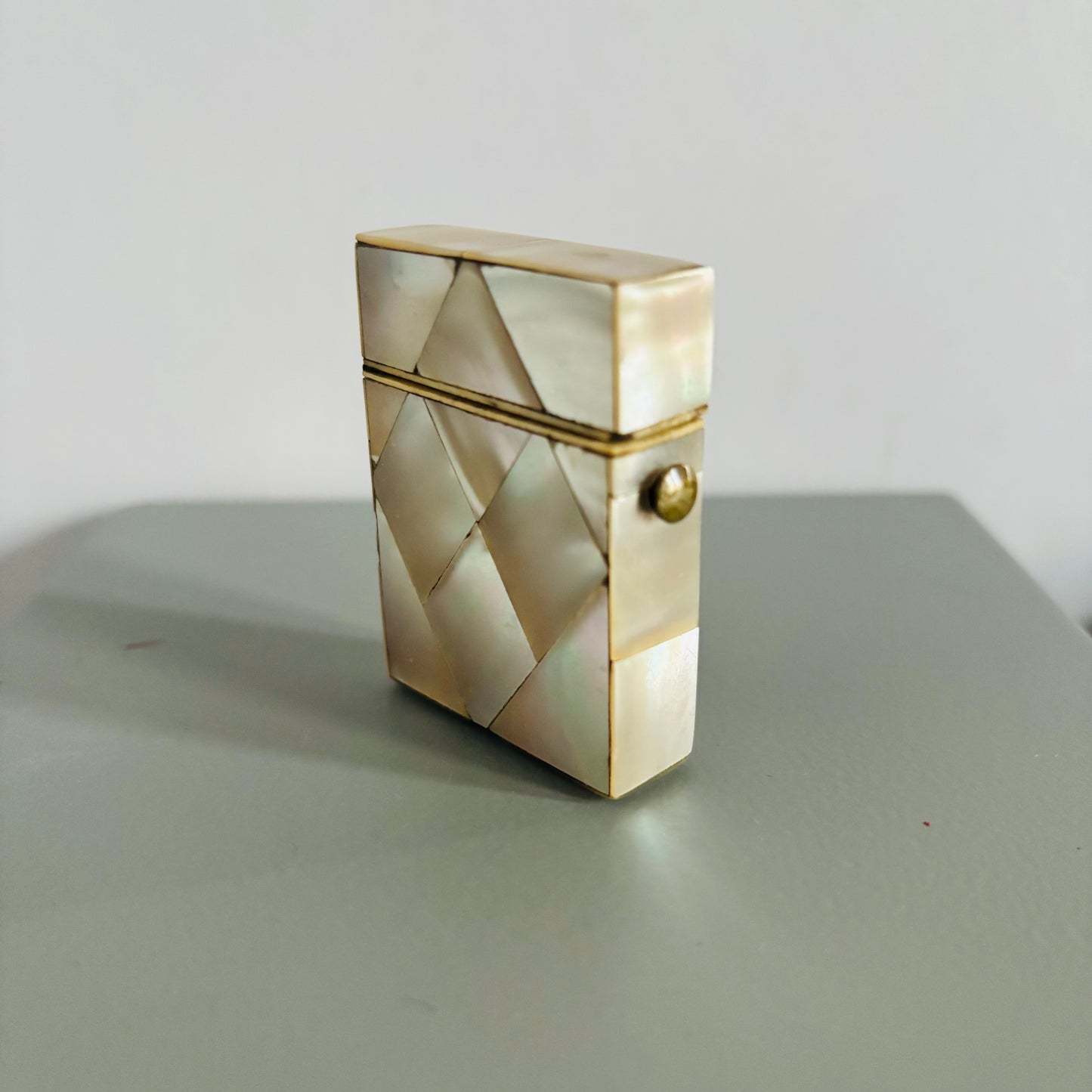 Decorative box with geometric pattern on a gray surface