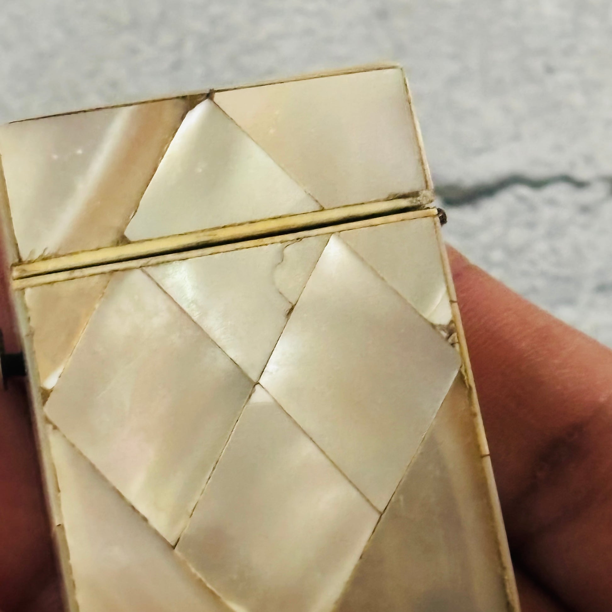 Close-up of Decorative Rare Antique Mother Of Pearl Vesta held by a hand.