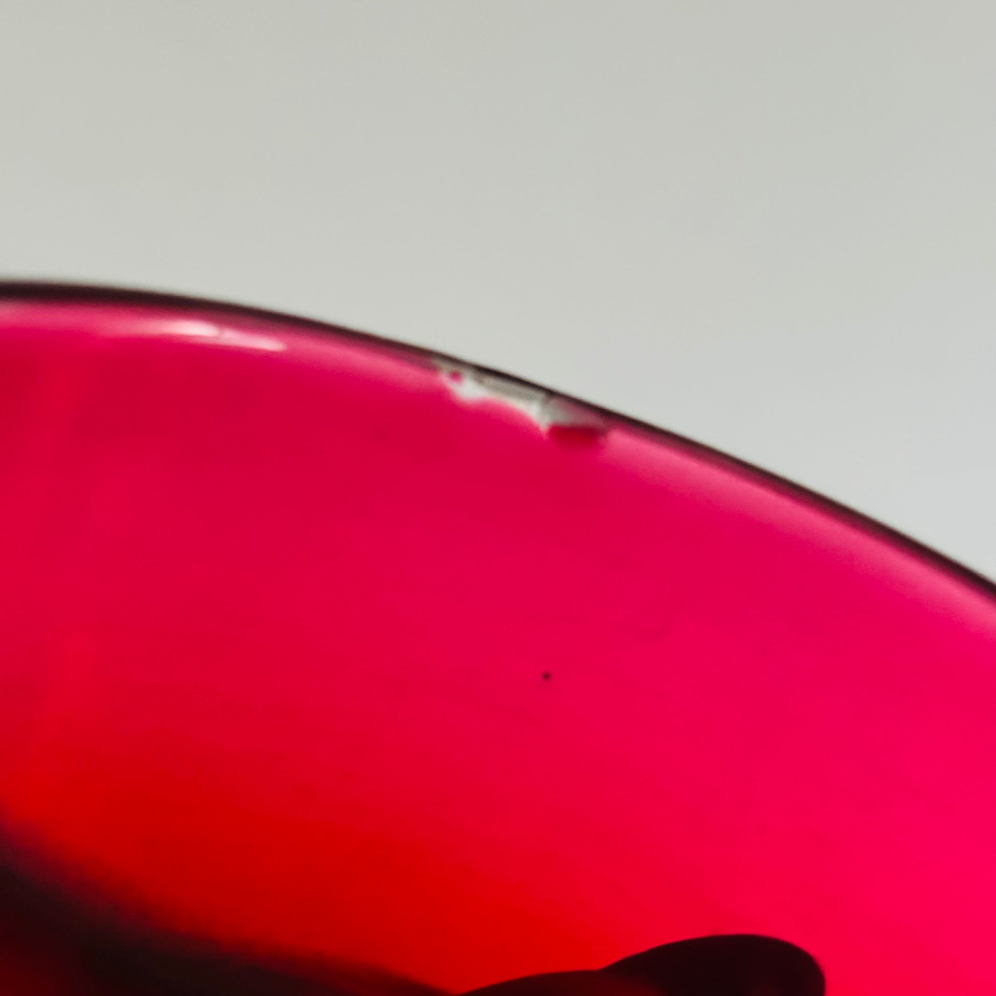 Close-up of a red glass liner with a blurred background
