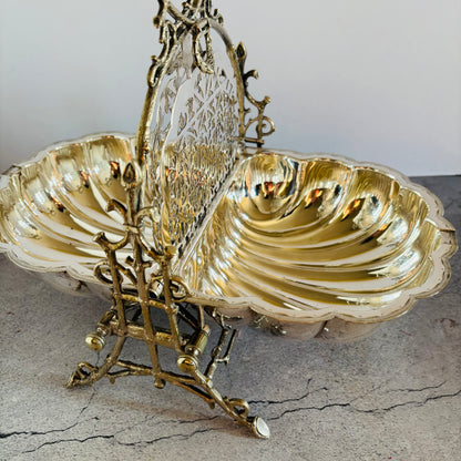 Decorative antique silver shell dish with intricate design on a textured surface