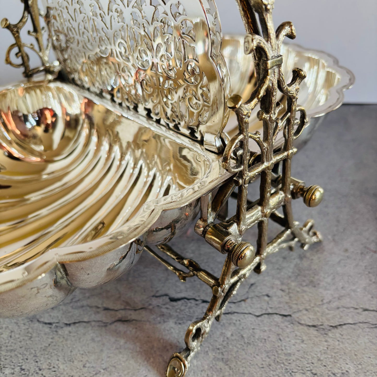 Decorative metal bowl with intricate designs on a textured surface