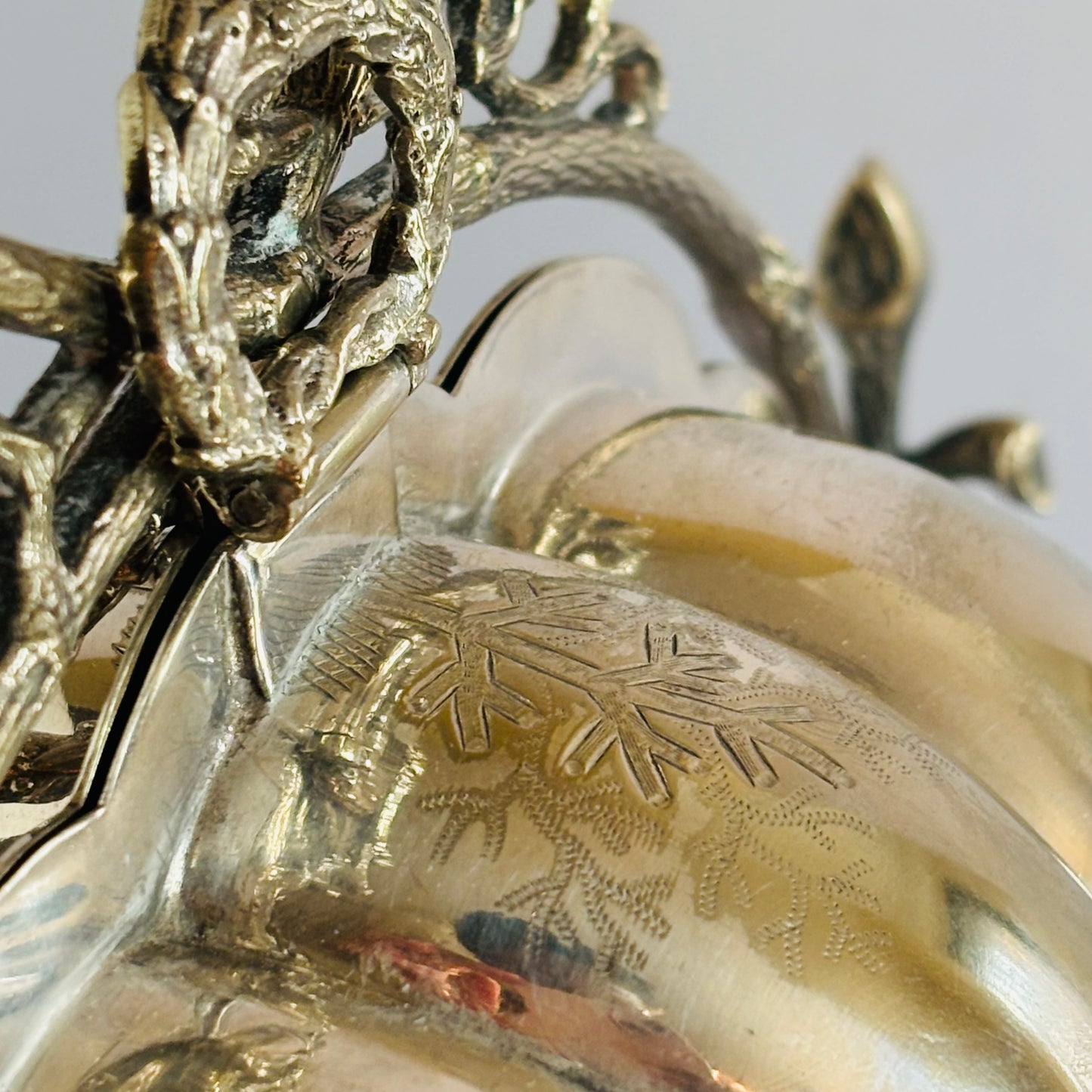Close-up of a decorative object with intricate designs on a plain background