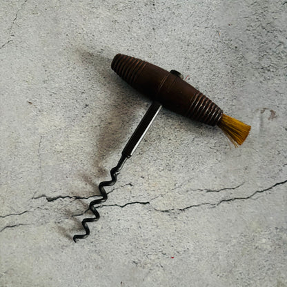 Corkscrew with a brush on a concrete surface