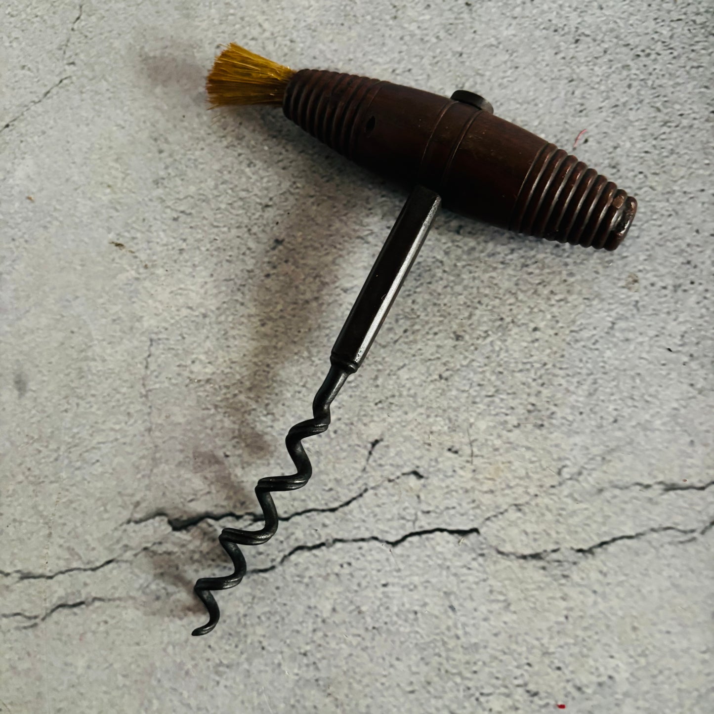 Corkscrew with a brush on a textured surface