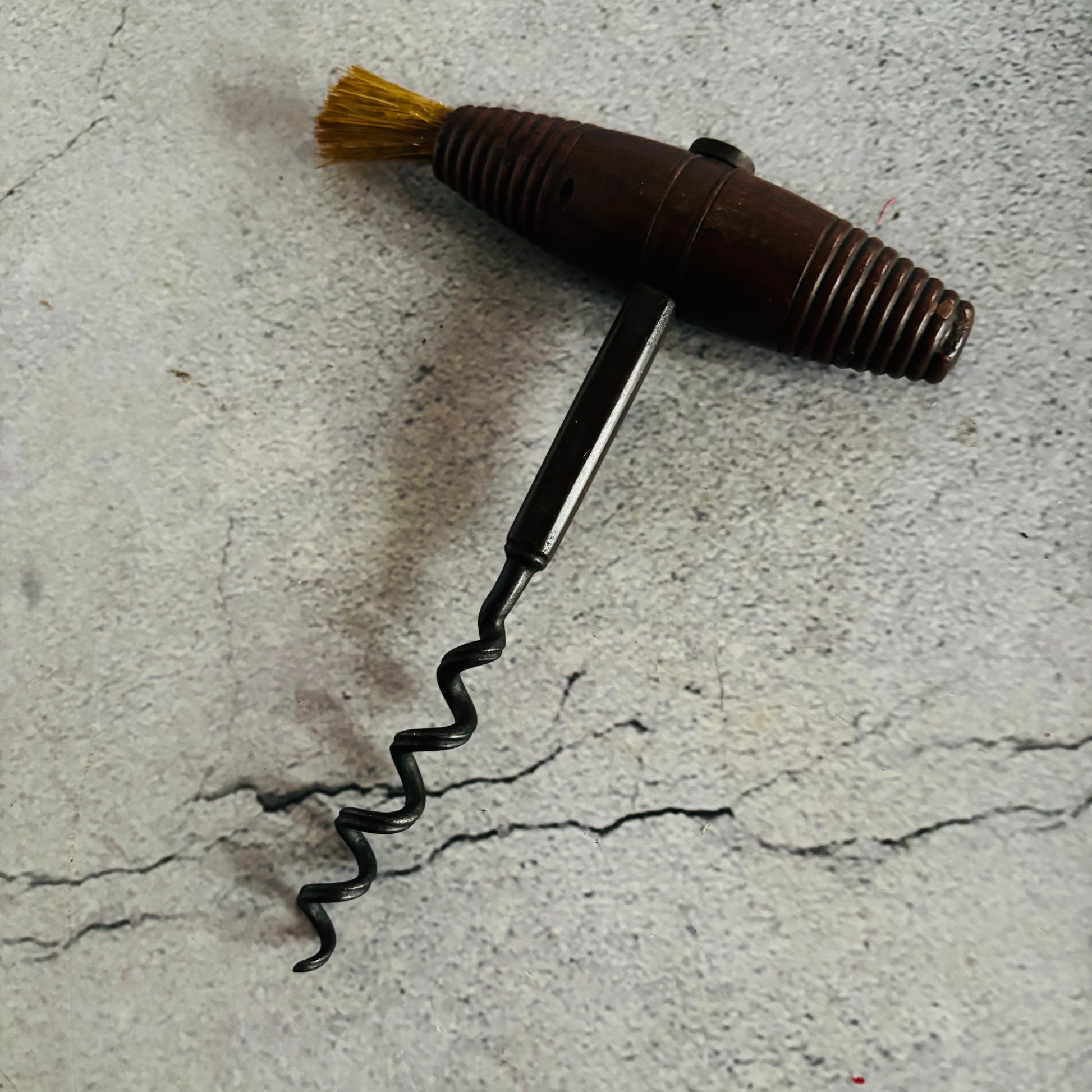 Corkscrew with a brush on a textured surface
