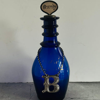 The Director Kasey - Antique Silver Letter Decanter Label