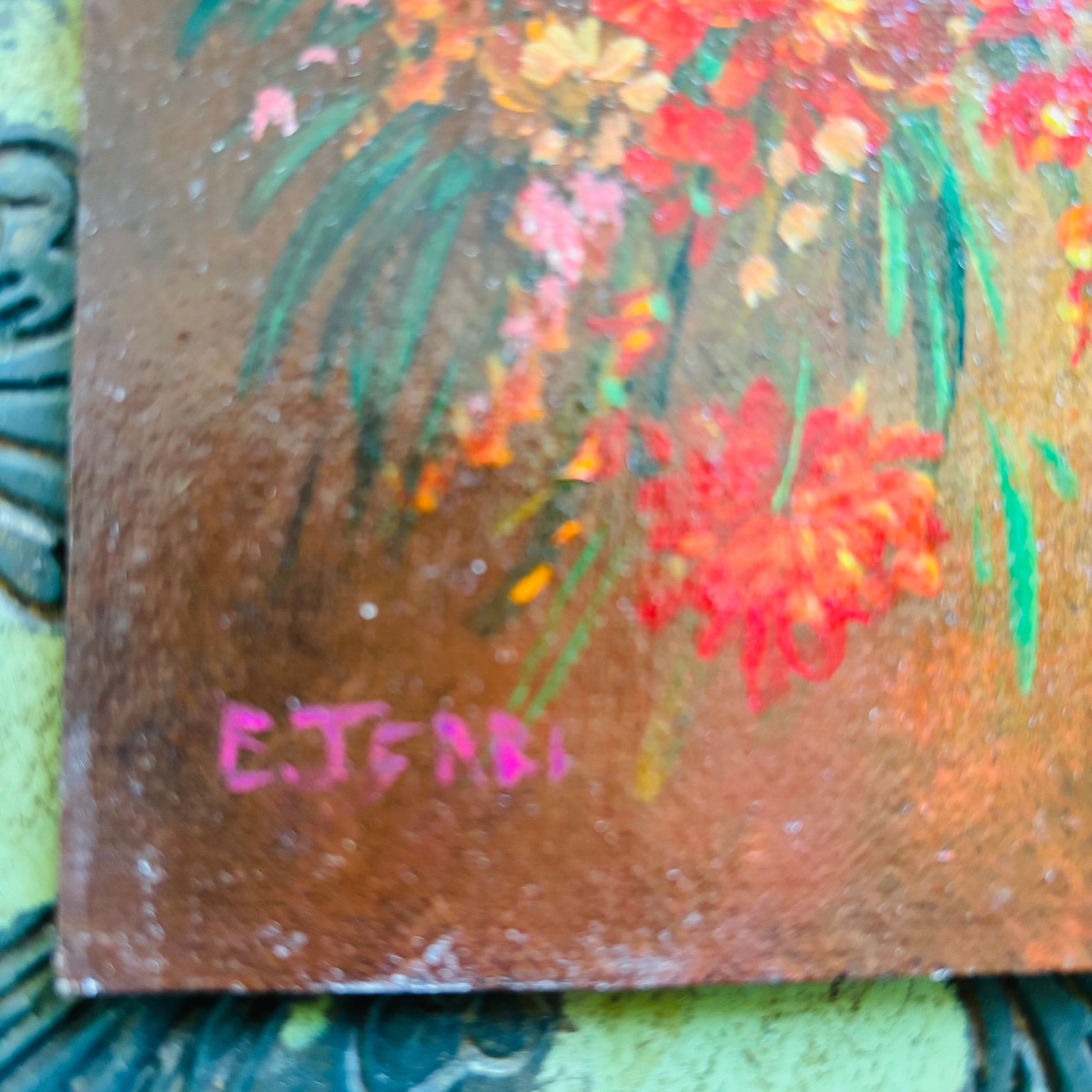Small painting of flowers with 'E. Terri' signature on a textured surface