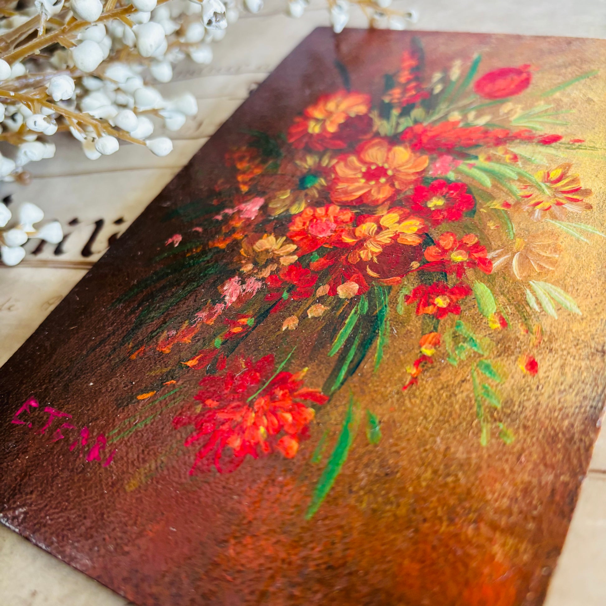 Vintage-style painting of flowers on a wooden panel with white flowers in the background.