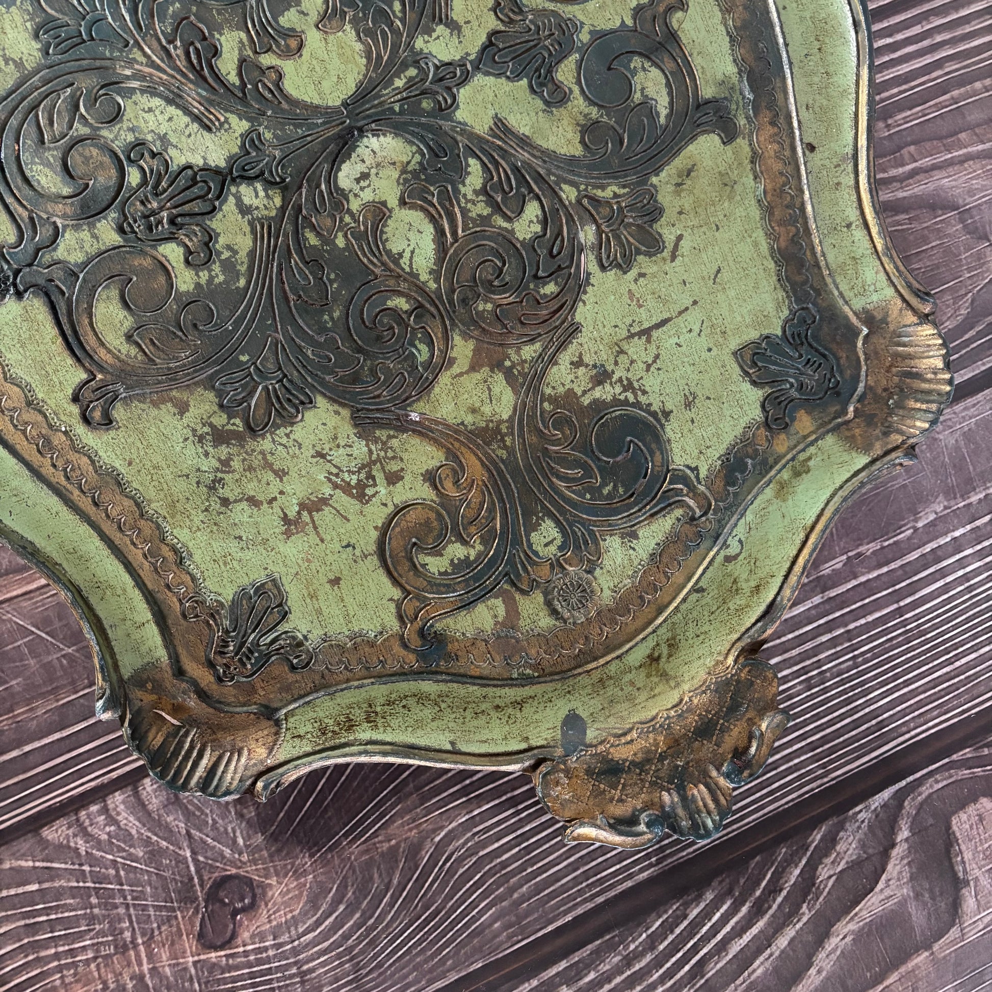 Decorative metal object with intricate patterns on a wooden surface