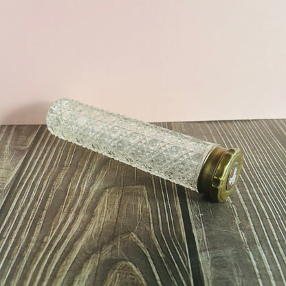 Decorative roller with textured design on a wooden surface