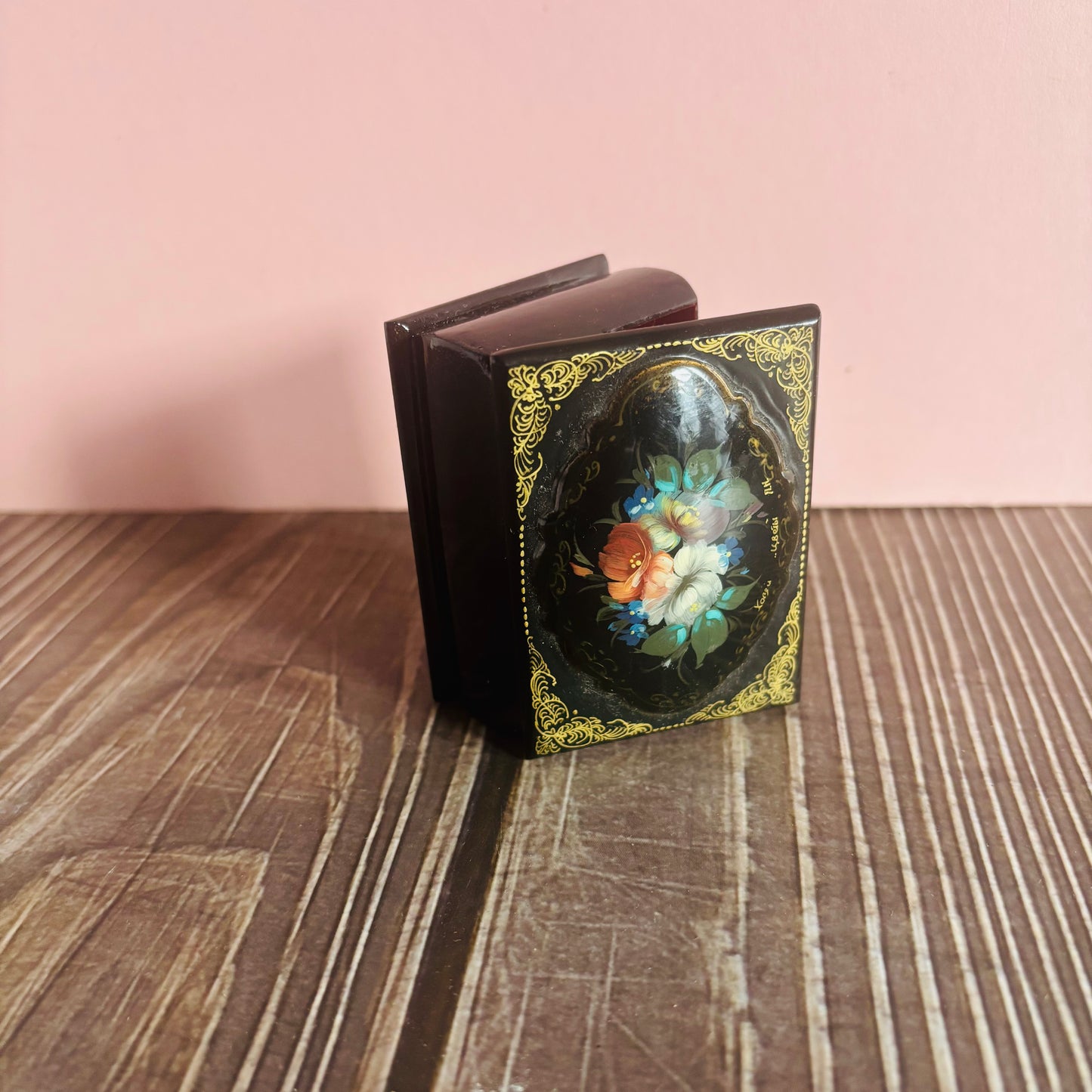 Decorative book with floral design on a wooden surface