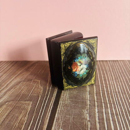 Decorative book with floral design on a wooden surface