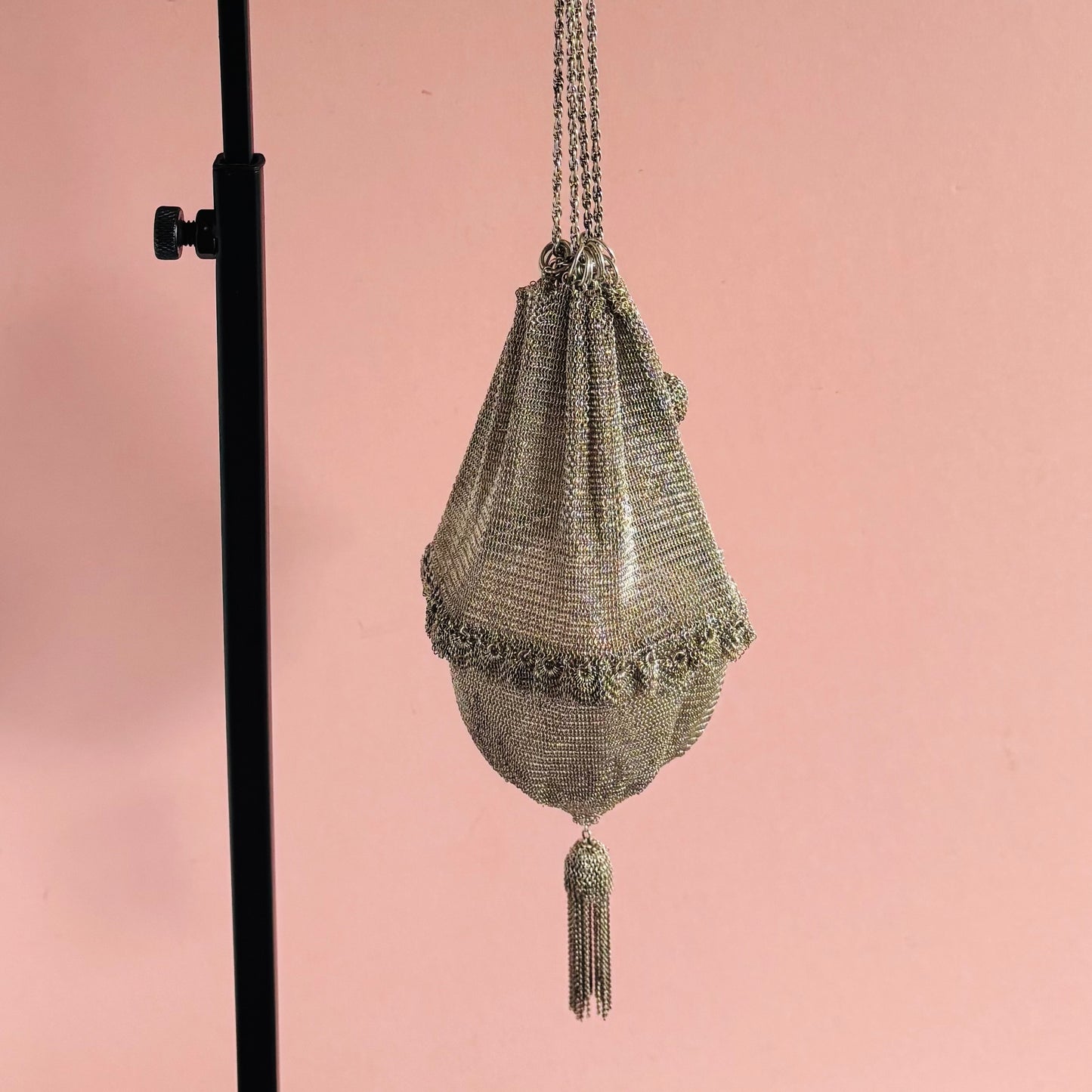 Silver Chainmail Pouch Bag with tassel on a pink background