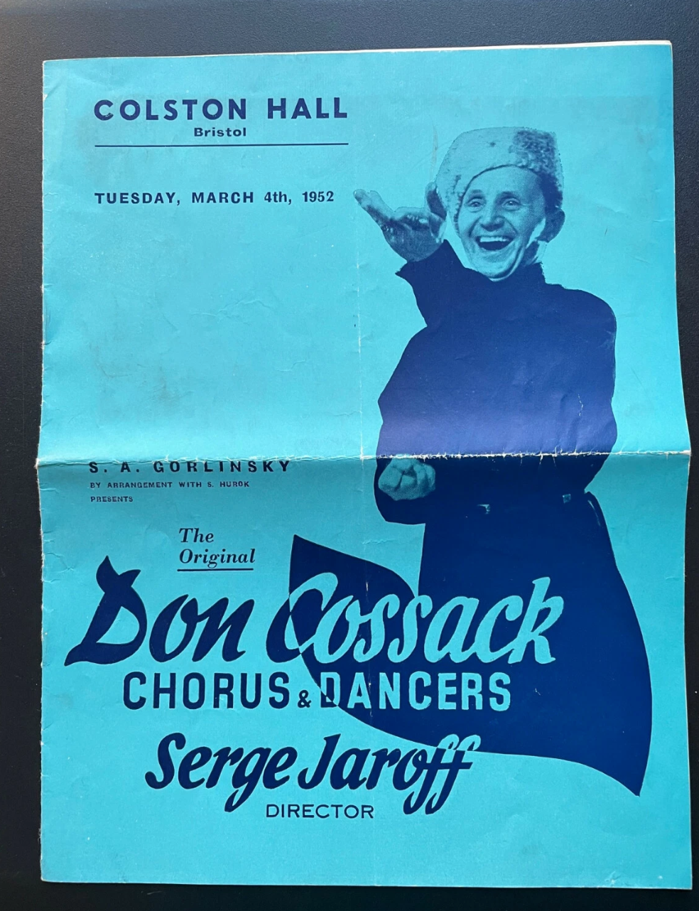 Promotional poster for the Don Cossack Chorus & Dancers at Colston Hall, Bristol, featuring a smiling man in a coat.